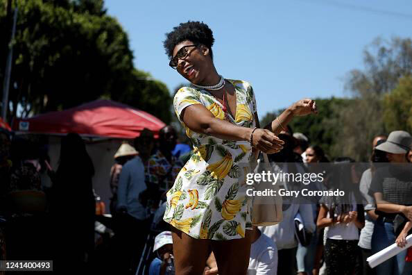 Celebrity Massage Therapist Tiya like Fiya dances in the drum circle on Juneteenth. -LA Times News Paper